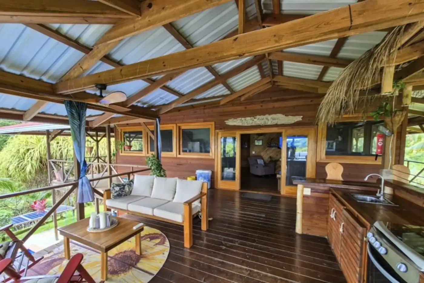 Open-concept living and kitchen area with vaulted wood ceiling